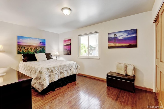 5986 Dunraven St, Golden, CO 80403 - bedroom featuring wood-type flooring and baseboards