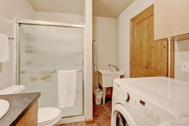 5986 Dunraven St, Golden, CO 80403 - bathroom with washer / clothes dryer, vanity, a stall shower, toilet, and tile patterned floors