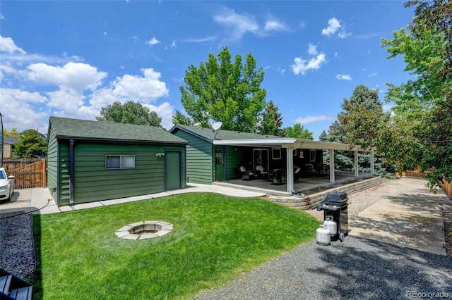 5986 Dunraven St, Golden, CO 80403 - view of front facade with a patio, roof with shingles, a carport, and driveway