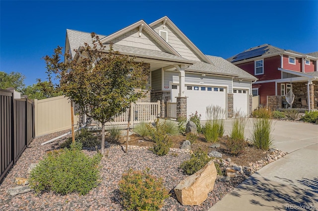 4403 Picadilly Ct, Aurora, CO 80019 - view of front facade featuring covered porch, a garage, stone siding, driveway, and roof with shingles