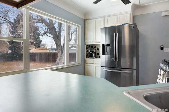 kitchen with stainless steel appliances, light countertops, a ceiling fan, and white cabinetry