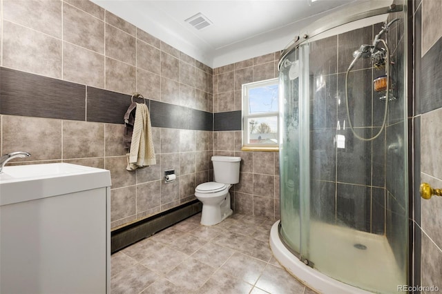 full bath with visible vents, tile patterned floors, vanity, a shower stall, and tile walls