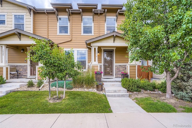 1519 S Dayton St, Denver, CO 80247 - view of front of home featuring stone siding and a front yard