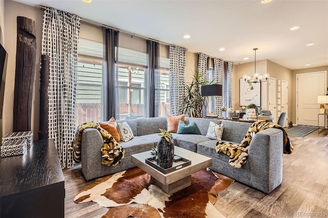 1519 S Dayton St, Denver, CO 80247 - living room featuring wood finished floors, a chandelier, and recessed lighting