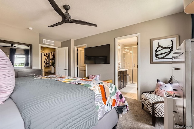 1519 S Dayton St, Denver, CO 80247 - bedroom featuring ensuite bathroom, a ceiling fan, and light colored carpet
