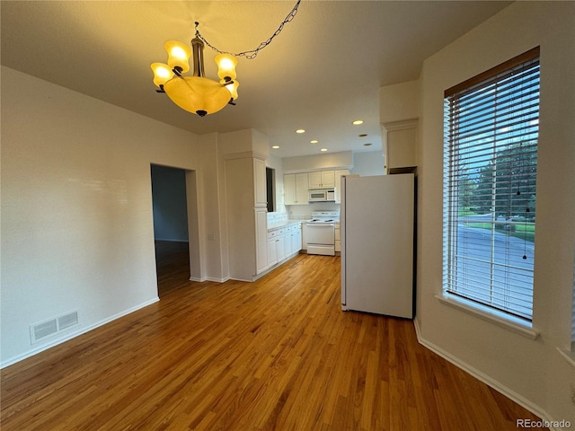 interior space featuring a notable chandelier and light hardwood / wood-style flooring