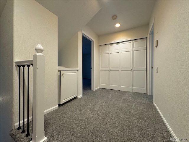 unfurnished bedroom featuring dark carpet and a closet