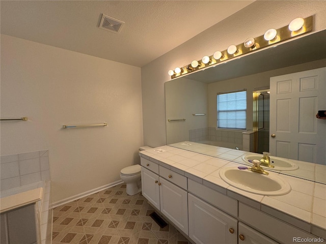 bathroom with vanity, a textured ceiling, toilet, and an enclosed shower