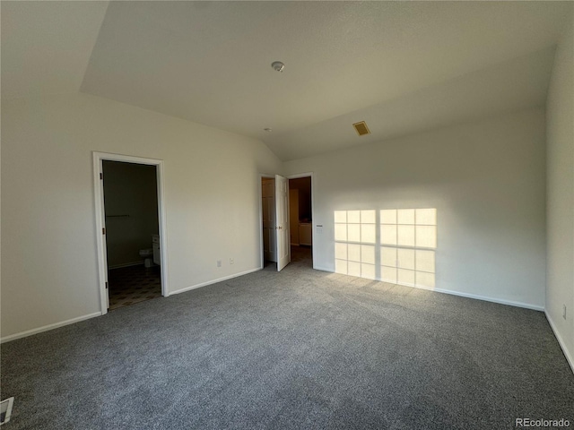 carpeted empty room featuring lofted ceiling