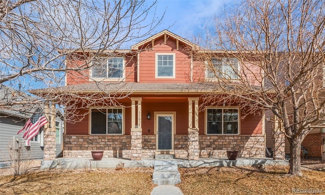 craftsman-style house featuring a porch, stone siding, and a shingled roof