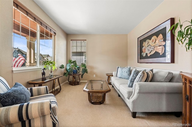 carpeted living room with baseboards