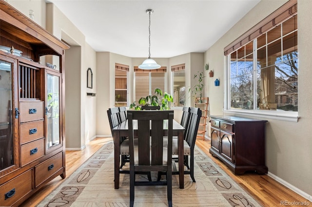 dining room featuring light wood-style floors and baseboards