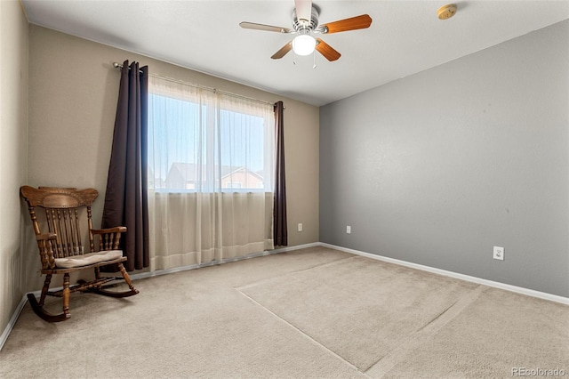 empty room with carpet floors, baseboards, and a ceiling fan