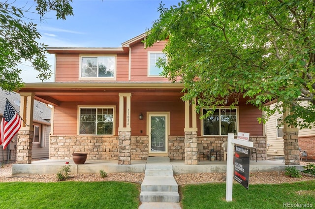 11034 Nome St, Commerce City, CO 80640 - craftsman-style home with a porch, stone siding, and a front lawn