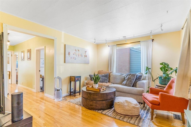 4476 S Lincoln St, Englewood, CO 80113 - living area featuring rail lighting, baseboards, light wood-style flooring, and visible vents
