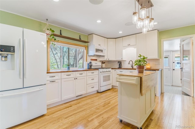 4476 S Lincoln St, Englewood, CO 80113 - kitchen with backsplash, white appliances, light wood-style flooring, and plenty of natural light