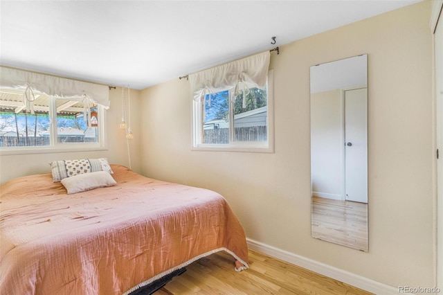 4476 S Lincoln St, Englewood, CO 80113 - bedroom with baseboards, multiple windows, and wood finished floors
