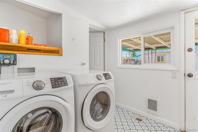 4476 S Lincoln St, Englewood, CO 80113 - laundry area with baseboards, laundry area, visible vents, and washer and clothes dryer