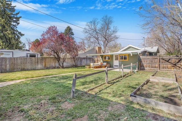 4476 S Lincoln St, Englewood, CO 80113 - view of yard with an outdoor hangout area, a garden, and a fenced backyard
