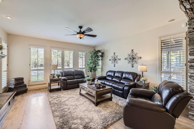 living room featuring ceiling fan and light wood-type flooring