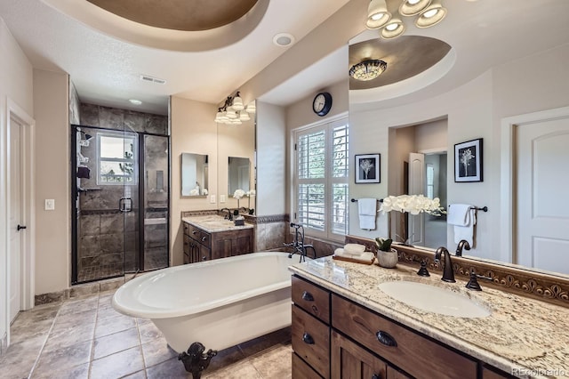 bathroom featuring a shower stall, a freestanding tub, plenty of natural light, and a sink