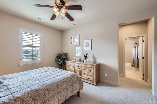 bedroom featuring baseboards, ceiling fan, light carpet, and visible vents
