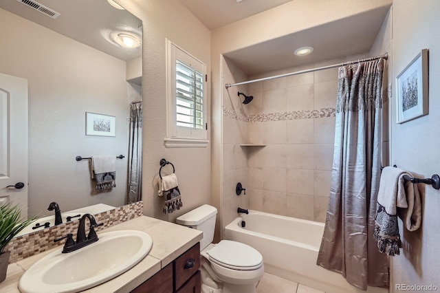 full bathroom with visible vents, tile patterned flooring, vanity, shower / bath combination with curtain, and toilet
