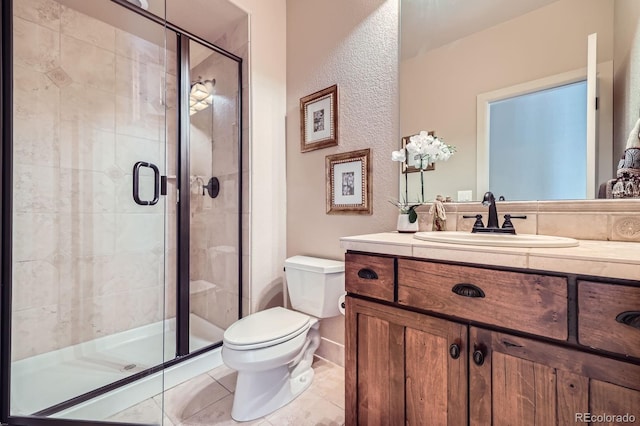bathroom with vanity, tile patterned floors, a stall shower, and toilet