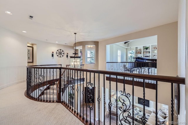 hall with visible vents, recessed lighting, carpet, and a notable chandelier