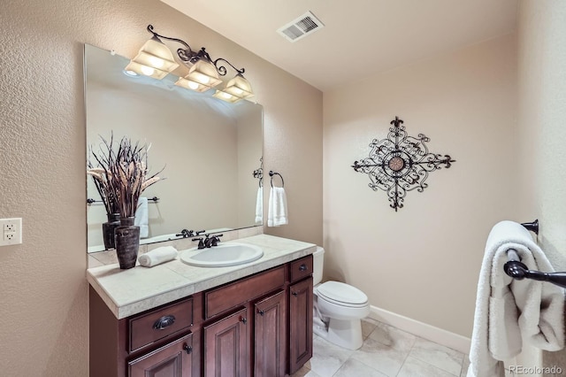 bathroom with visible vents, tile patterned floors, toilet, and vanity