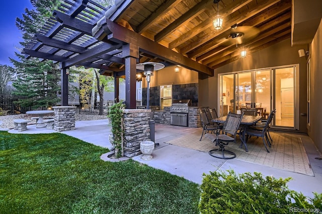 view of patio with grilling area, exterior kitchen, fence, and a pergola