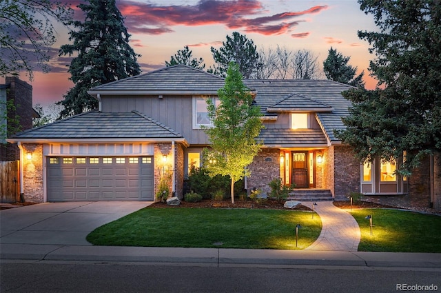 10849 E Crestridge Cir, Englewood, CO 80111 - view of front of house with concrete driveway, a garage, brick siding, and board and batten siding