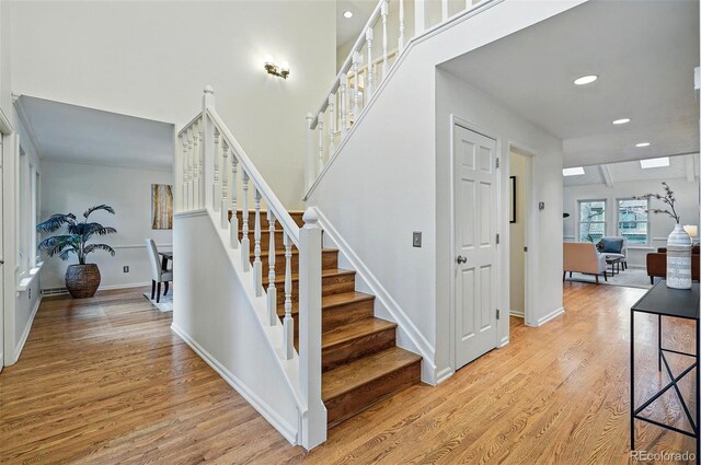 10849 E Crestridge Cir, Englewood, CO 80111 - stairs featuring wood finished floors, baseboards, and recessed lighting