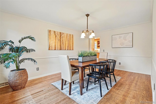 10849 E Crestridge Cir, Englewood, CO 80111 - dining area featuring a chandelier, light wood finished floors, ornamental molding, and baseboards