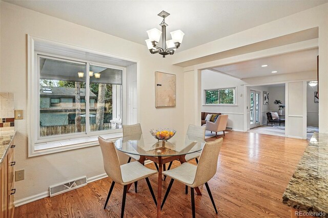 10849 E Crestridge Cir, Englewood, CO 80111 - dining space featuring baseboards, a chandelier, and wood finished floors