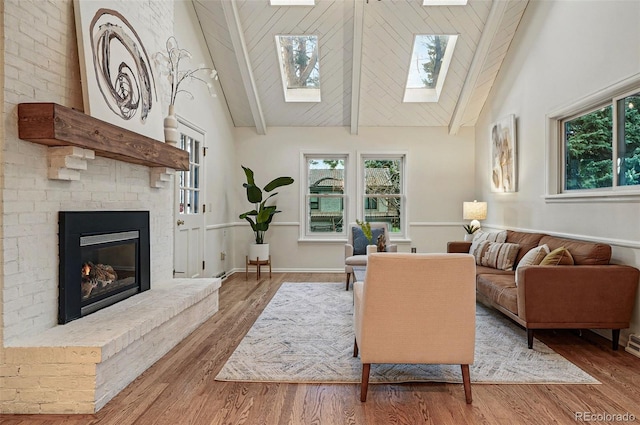 10849 E Crestridge Cir, Englewood, CO 80111 - living area featuring a skylight, a brick fireplace, wood finished floors, high vaulted ceiling, and plenty of natural light