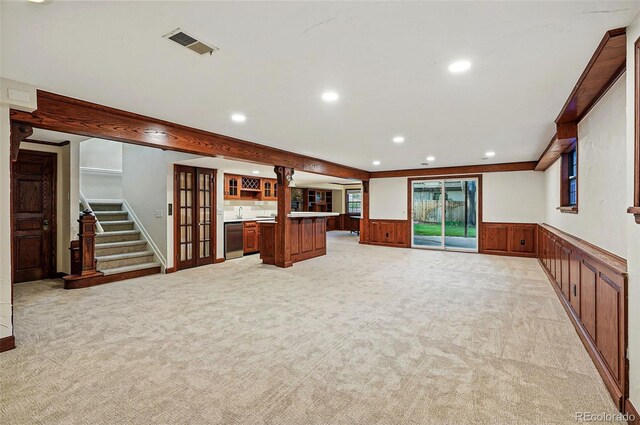 10849 E Crestridge Cir, Englewood, CO 80111 - unfurnished living room with light colored carpet, a wainscoted wall, recessed lighting, and stairs