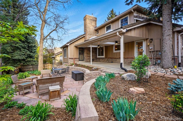 10849 E Crestridge Cir, Englewood, CO 80111 - rear view of house featuring a patio area, a ceiling fan, a chimney, fence, and board and batten siding