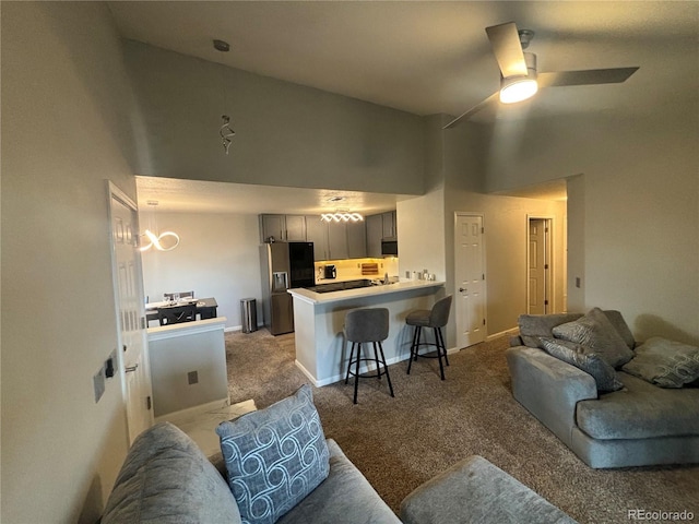 carpeted living room featuring high vaulted ceiling and ceiling fan