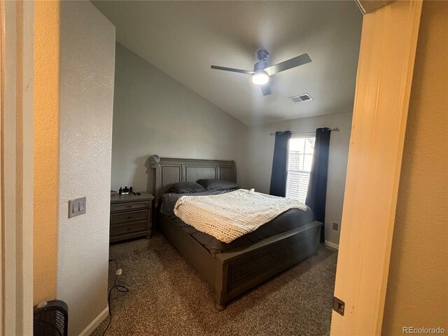 bedroom with dark colored carpet, vaulted ceiling, and ceiling fan