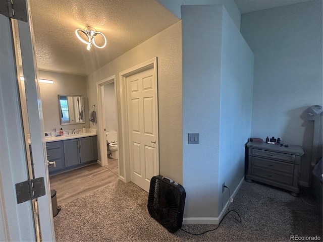 bathroom with vanity, a textured ceiling, and toilet