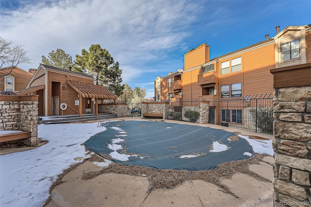 view of swimming pool with fence