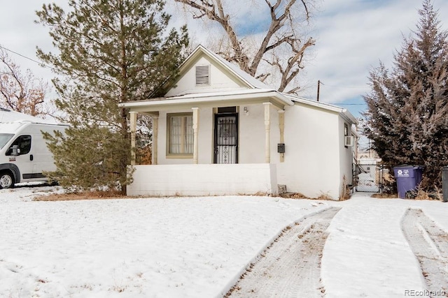 view of front facade with fence, a gate, and stucco siding