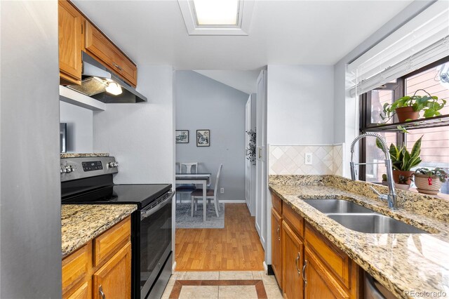 kitchen with sink, tasteful backsplash, ventilation hood, light stone countertops, and stainless steel electric range oven