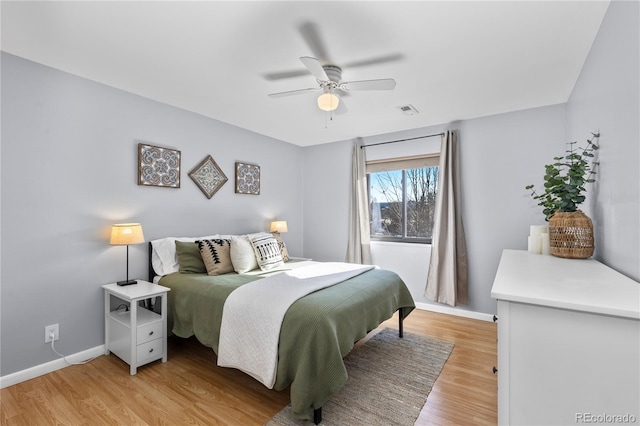 bedroom with ceiling fan and light hardwood / wood-style flooring