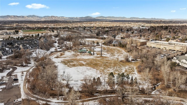 snowy aerial view with a mountain view