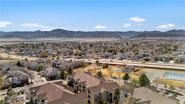 aerial view of property's location with nearby suburban area and a mountain backdrop