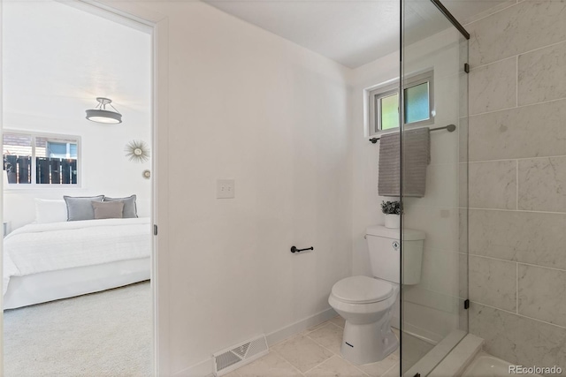 bathroom featuring toilet and tile patterned flooring