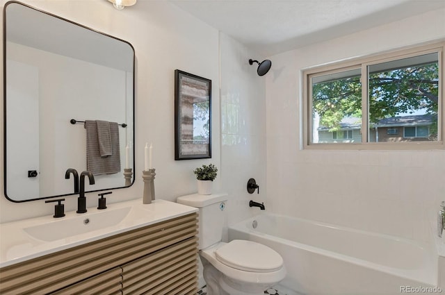 full bathroom featuring tiled shower / bath combo, vanity, and toilet