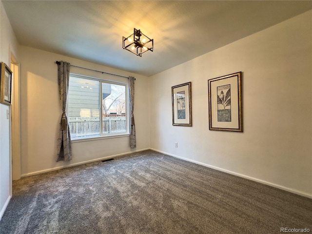 unfurnished room featuring dark carpet